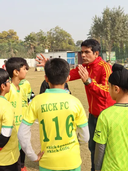A quick huddle before the game is where strategy meets motivation. Here, one of our coaches discusses tactics with the team, ensuring every player understands their role. We believe clear communication and mentorship are key to building a confident team.