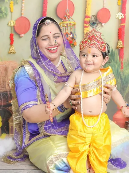 A playful and happy moment during a mother-son Krishna themed session.