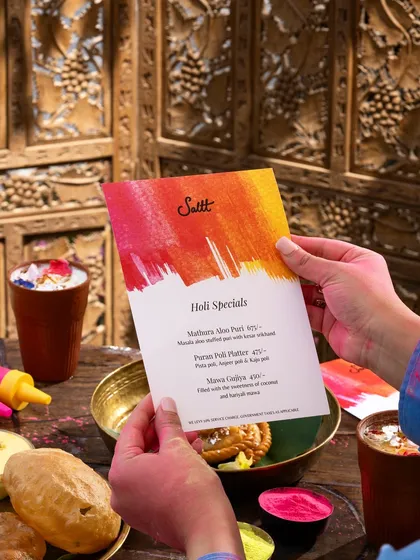 A shot of the special Holi menu, surrounded by festive colors and dishes.