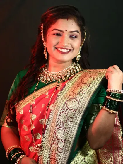 A happy and radiant smile from the bride. Her makeup is glamorous yet natural, perfect for celebrating her special day.
