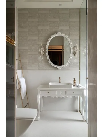 The all-white master bathroom in the "Cityscape Serenity" home is pure elegance. It features a classic carved vanity, an ornate mirror, and crystal wall sconces, creating a serene, spa-like atmosphere.