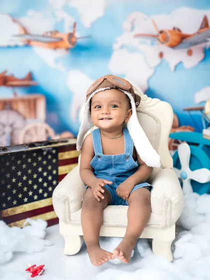 A happy smile from the pilot's seat. This little one loved his aviator-themed milestone session.