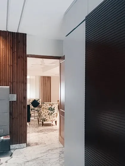 This image from a finished project highlights the interplay of textures, with a dark fluted wardrobe door contrasting against a warm wood-paneled wall. This detail shows my focus on material selection in residential design.