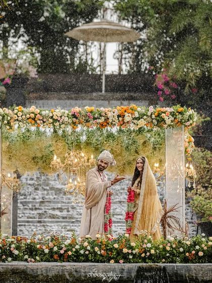 The couple at their mandap during a sudden rain shower, which only added to the magic of the moment.