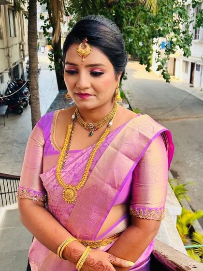 A candid shot showing the soft, blended eye makeup and how it complements the traditional gold jewellery.