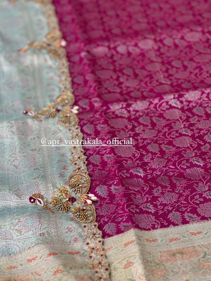 A beautiful border with peacock-inspired zardosi work, placed between a light blue and a rich pink brocade.
