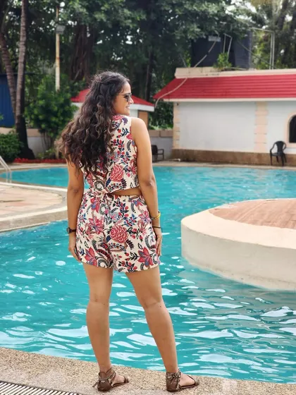 A back view of my pool party outfit, enjoying the serene view before the guests arrive.