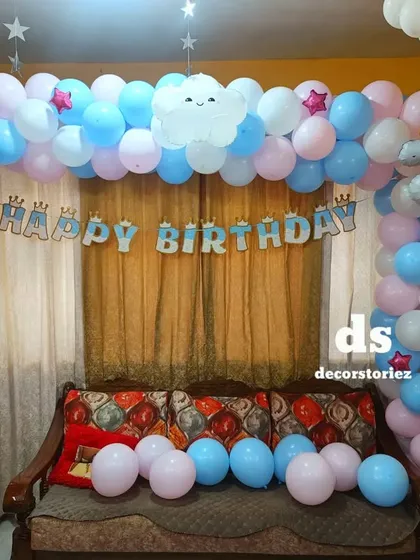 A dreamy rainbow and unicorn themed party setup. This decoration features a pastel balloon arch with a unicorn foil, a rainbow cutout, and a 'Happy Birthday' banner, creating a magical atmosphere in your home.