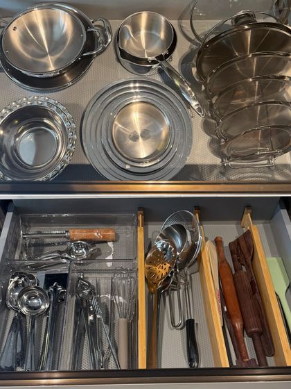 A two-part view showing a drawer for steel serving bowls and another for cooking utensils. This demonstrates how we create specific zones for different kitchen functions.