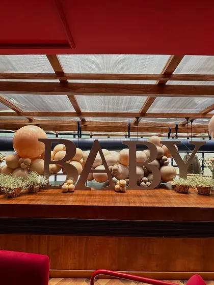 The "BABY" bar installation seen from a distance, demonstrating how a single decorative element can define a space.