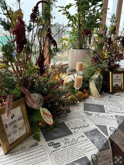 A table setting with a framed sign that reads 'A little one is on the way,' perfectly capturing the event's purpose.