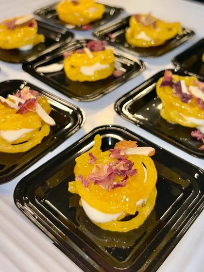 My Rabdi Jalebi is a delightful fusion of two classic Indian sweets. A crispy, syrup soaked jalebi is filled with rich and creamy rabdi, creating a perfect bite of sweetness and texture.