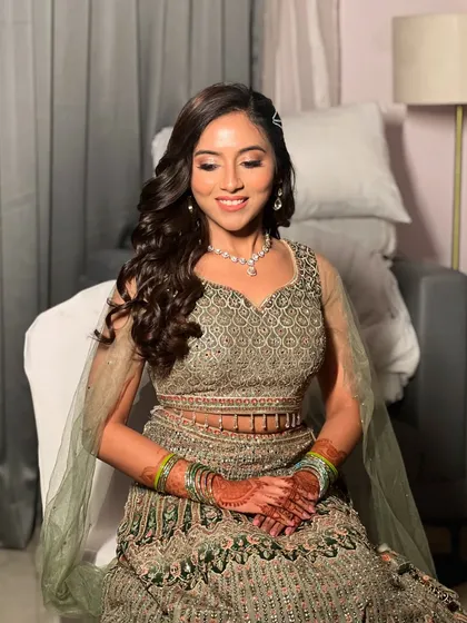 The full Sangeet look, with soft curls and a beautiful olive green lehenga.