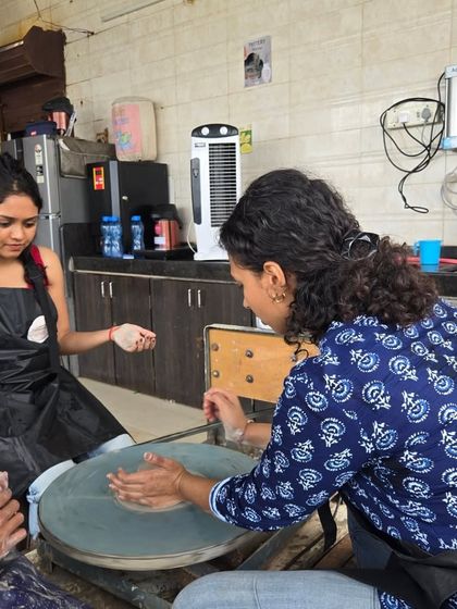 Here I am providing instruction to a participant at the wheel. I'm always on hand to offer tips and help you get the feel for the clay.