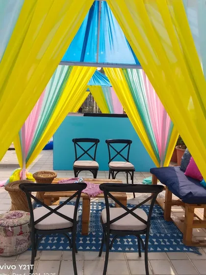 A cozy cabana seating arrangement perfect for a relaxed Mehndi or Haldi function. The colorful drapes and comfortable seating create an inviting space for guests to chat and relax.