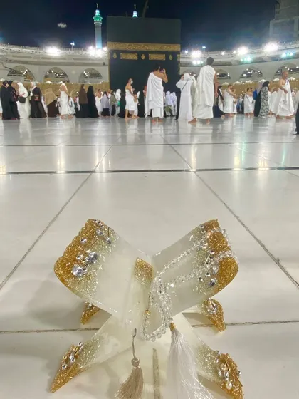 A beautiful shot of my white and gold Quran holder with a crystal tasbeeh, placed with the Kaaba in the background. A perfect gift for Ramadan, Hajj, or Umrah.