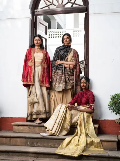 This group shot for a luxury ethnic wear campaign showcases my approach to cohesive collection styling. I balanced different silhouettes, from a draped saree to a structured jacket, using a unified color story of reds and earthy tones to create a powerful, harmonious composition.
