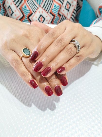 Another view of the classic maroon manicure, showing its rich color and flawless application.