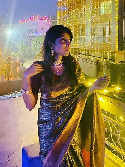 Another shot of my Diwali look on the terrace, surrounded by lights. The rich fabric of the saree catches the light beautifully, making it perfect for an evening celebration.