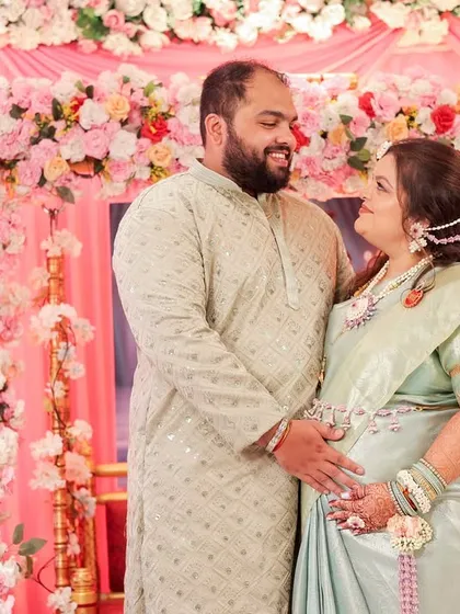 A lovely couple portrait from a baby shower. The mom-to-be is wearing a custom set I designed with white and purple flowers to match her beautiful pastel saree.
