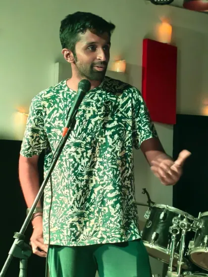 A storyteller captivating the room during one of our intimate sessions. The simple setup with just a mic allows the power of words to take center stage.