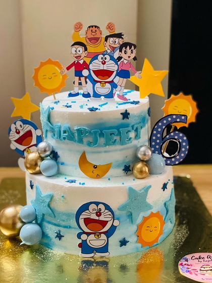 A two-tier Doraemon cake, perfect for a 6th birthday, featuring the beloved character and his friends.