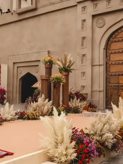 A side view of the wedding stage, highlighting the custom mural painted by the bride, which beautifully merged maps of India and Lebanon, symbolizing their union.