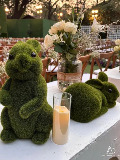 I love adding whimsical touches. These adorable moss bunnies served as unique decorative pieces, adding a playful and charming element to the elegant table setting.
