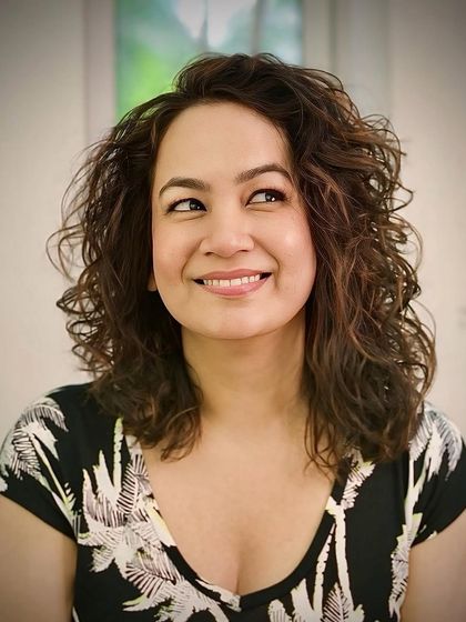 Embracing the curls in their natural state. This client's hair was cut and styled to maximize definition and minimize frizz.