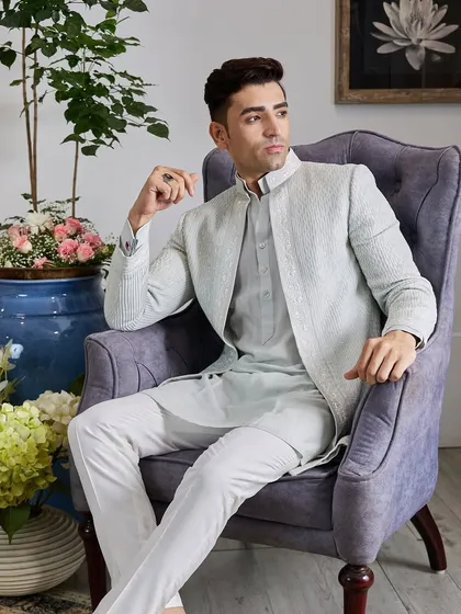 This pastel Indo-Western jacket is made for dazzling on the dance floor. The light-colored fabric is adorned with fine, textured embroidery, creating a look that is both elegant and festive.