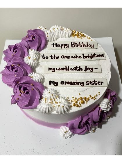 A Nutella truffle cake infused with liquor for a sister's birthday. The purple rosettes and gold sprinkles add a celebratory touch to this special message cake.