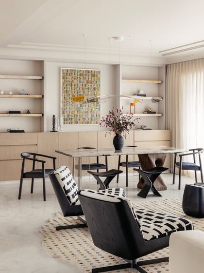 The full dining and living area, showcasing the open plan and the careful balance of neutral tones with pops of color and artistic details.