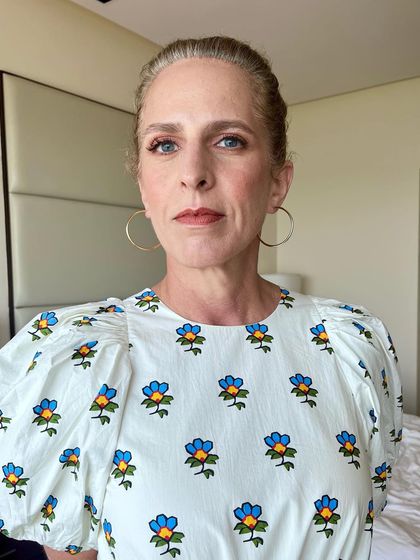 A portrait shot of the daytime look. The makeup focuses on a flawless base, subtly defined eyes, and a natural lip color.