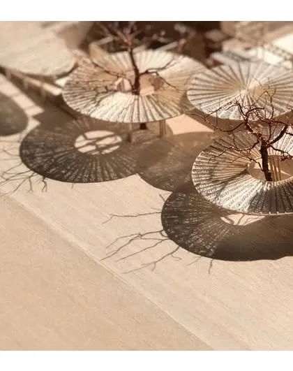 A detailed physical model of The Atelier's canopy system, demonstrating our hands-on approach to design. We study the intricate patterns of light and shadow, known as a moiré effect, to ensure our architectural elements create the intended atmosphere and visual poetry.