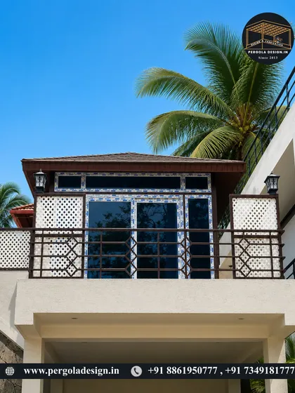 This exterior shot showcases how our glass room integrates perfectly with the existing architecture, turning an open balcony into a premium, usable space with elegant lighting and a durable, shingled roof.