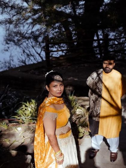 A stylish portrait of the couple posing on a path by the lake, the shadows and light creating a dramatic effect.