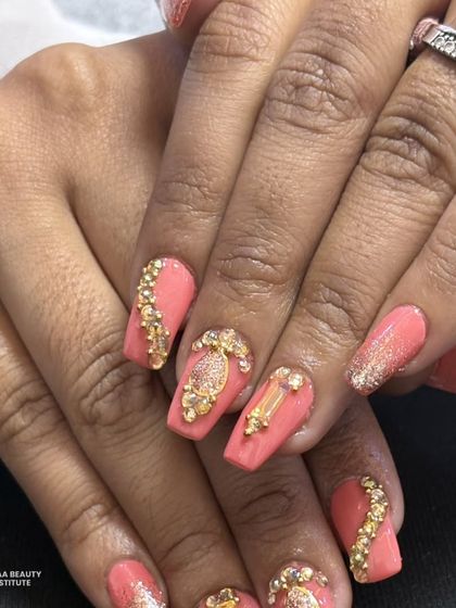 A close-up of the stunning gold and rhinestone details on this elegant nail set.