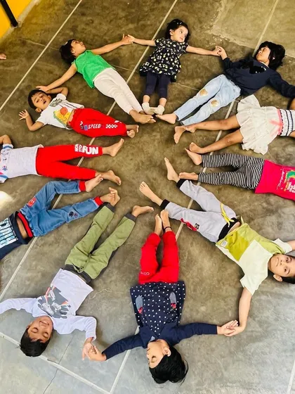 We create a "shining star" shape on the floor by working together. These creative group formations are a calm and fun way to end a session, reinforcing our connection as a team.