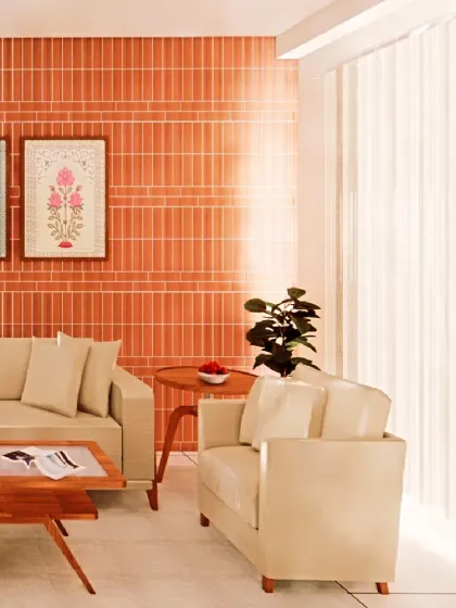 A terracotta tile accent wall adds a splash of color and earthy texture to the living room, creating a warm focal point without overwhelming the compact space. The light-colored sofa keeps the overall feel bright.