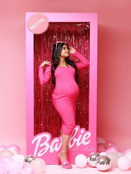 A sweet and playful pose inside the Barbie box, capturing the fun and excitement of this unique themed shoot.