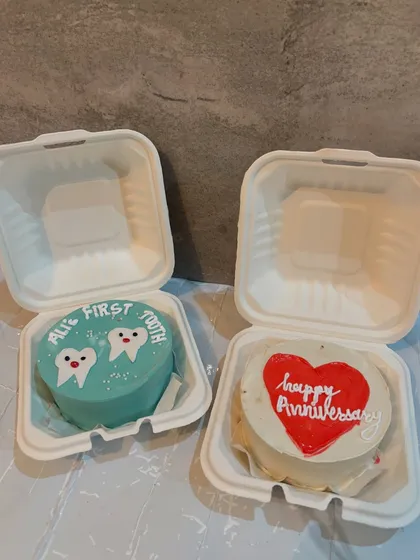 Two different celebrations, one sweet solution. Here are two bento cakes, one celebrating "Ali's First Tooth" and the other for a "Happy Anniversary," showing how versatile these mini cakes are.