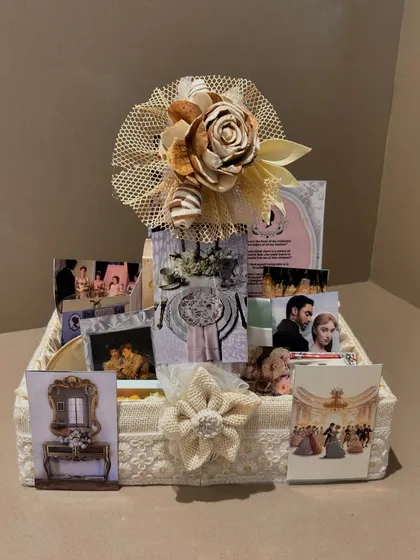 The front view of our popular Bridgerton hamper, showcasing the beautiful paper flower and themed cards that greet the recipient.