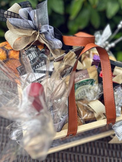 A glimpse of a luxury goodie basket designed for a new CEO. The focus here is on the careful wrapping and layering of gourmet items, promising a delightful unboxing experience.