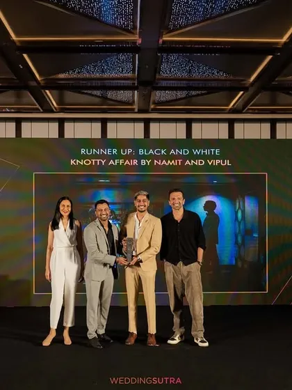 A wide shot of us accepting our award on stage. We are grateful for the recognition from the industry and our clients' trust.