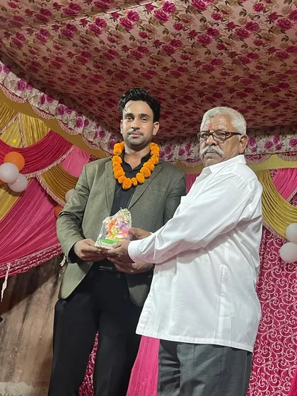 Being honored on stage with a garland and a memento at a local event.