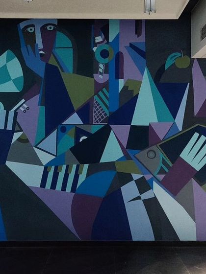 A cubist-inspired mural with a musical theme, featuring deconstructed instruments and figures in a cool, sophisticated palette.