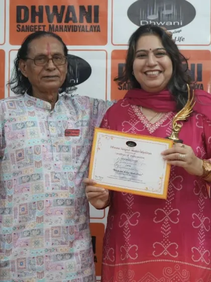 An adult student with her guru, celebrating her artistic journey.