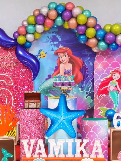 A magical 'Frozen 2' themed birthday party, transforming the venue into an enchanted forest with earthy tones, character cutouts, and shimmering backdrops.
