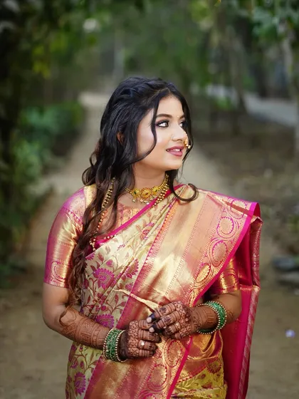 A candid side profile, showing the elegant hairstyle and the flawless finish of her makeup.