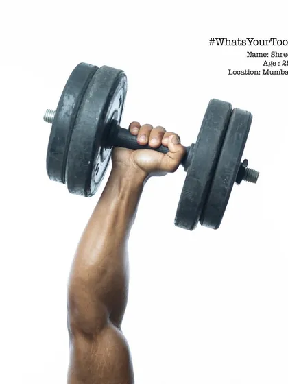 Shree, a 26-year-old from Mumbai, holding his dumbbell. This series was about honoring the instruments of our craft, whatever that craft may be.